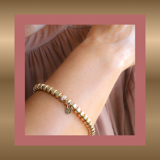 Exclusives - goldfilled armband met elementen in de vorm van wieltjes en zirkonia